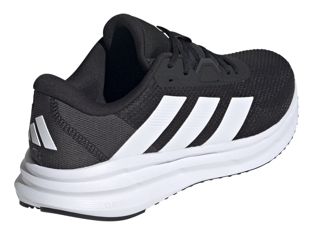 Tenis Adidas Galaxy 7 color negro con franjas y suela blanca, vista lateral.
