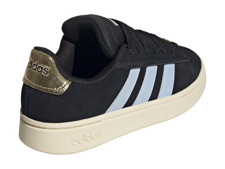 Tenis Adidas color negro con tres franjas azul claro y suela color crema.