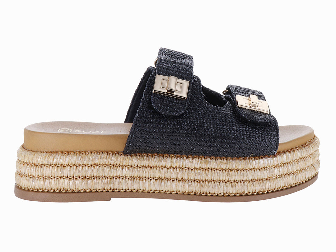 Sandalias de plataforma color negro con suela de yute tejido y hebillas doradas.