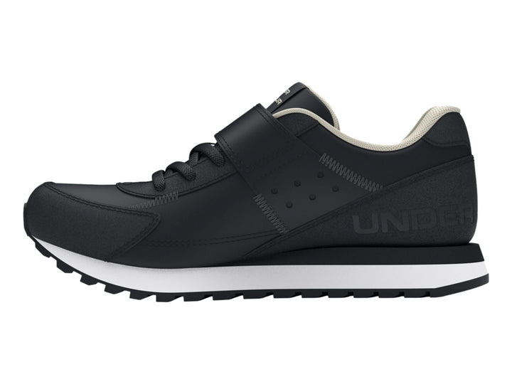 Tenis deportivos Under Armour color negro con suela blanca y cierre de cinta de velcro para niño.