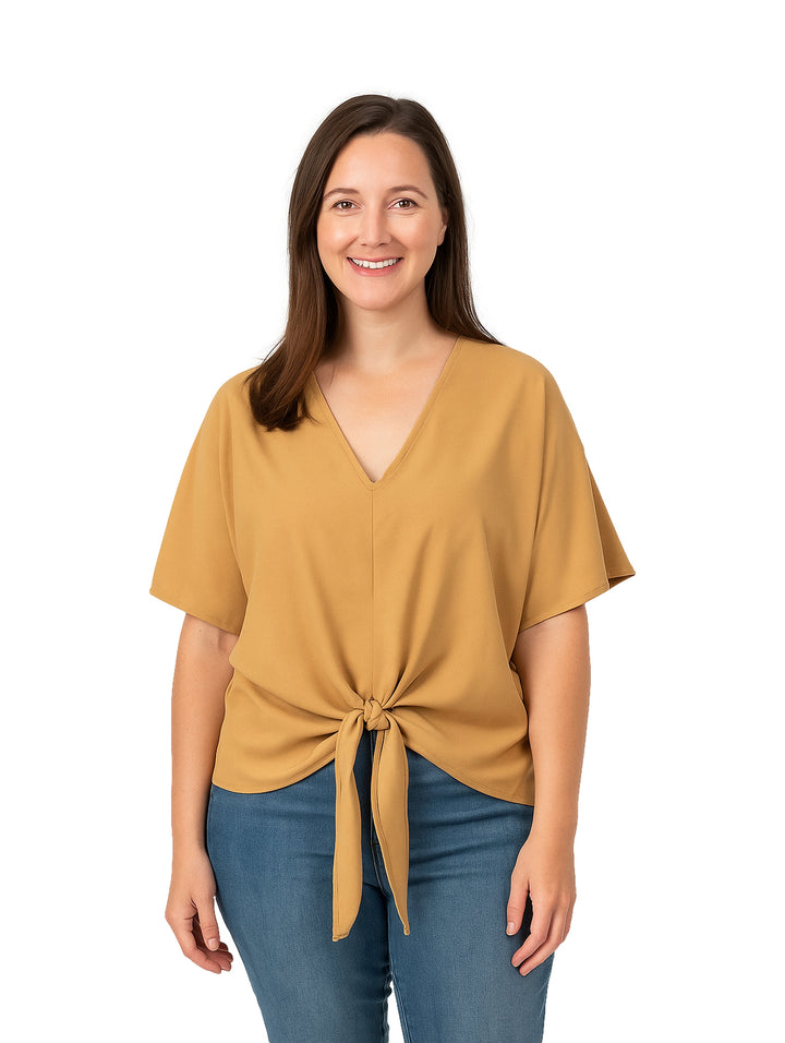 Mujer vistiendo una blusa color café con cuello en V y detalle de nudo en la cintura.