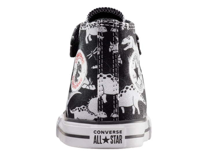 Tenis Converse Chuck Taylor All Star negros con estampado de dinosaurios blancos, punta blanca y cierre de velcro.