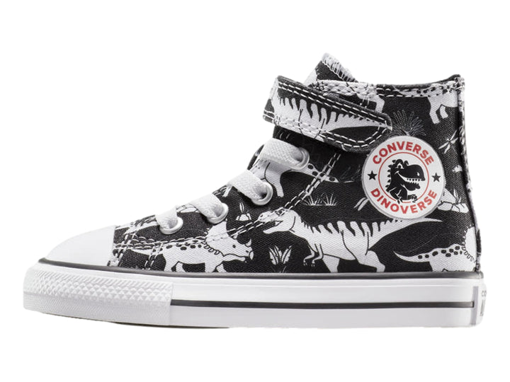 Tenis Converse Chuck Taylor All Star negros con estampado de dinosaurios blancos, punta blanca y cierre de velcro.