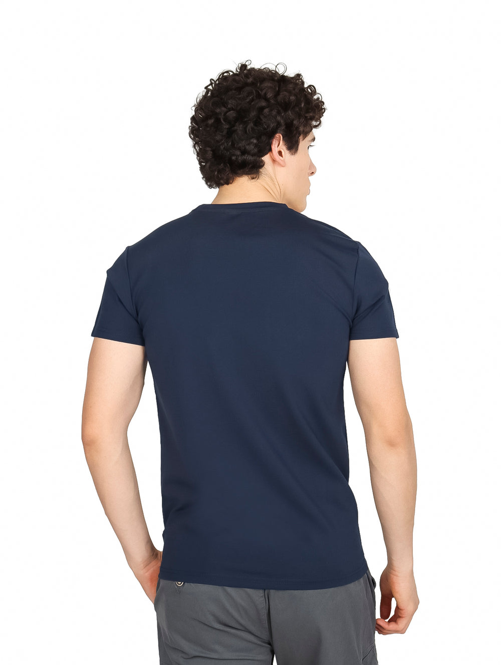 Hombre vistiendo una playera de manga corta color azul tibetano con corte oversize.