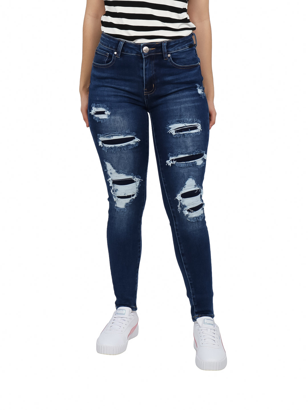Jeans skinny color azul oscuro con efecto desgastado y roturas decorativas en las piernas.