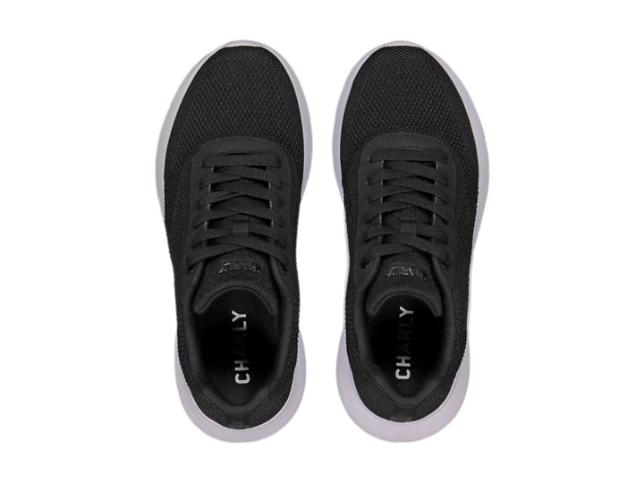 Tenis deportivos Charly color negro con suela blanca y tejido transpirable.