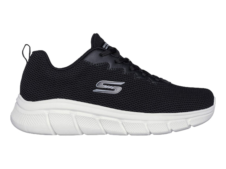 Tenis Skechers color negro con suela blanca y logotipo lateral en color gris.