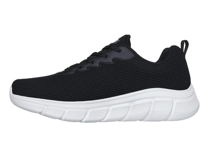 Tenis Skechers color negro con suela blanca y logotipo lateral en color gris.