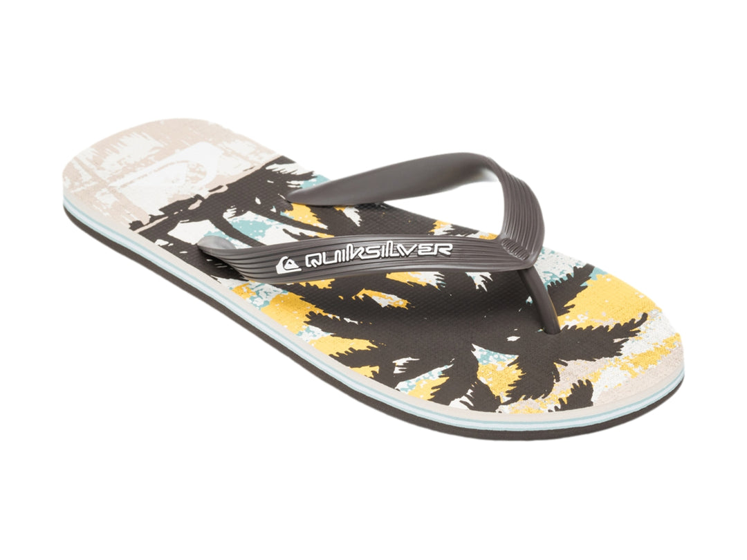 Sandalias Quiksilver de color blanco y negro con diseño tropical en la plantilla, vista lateral.