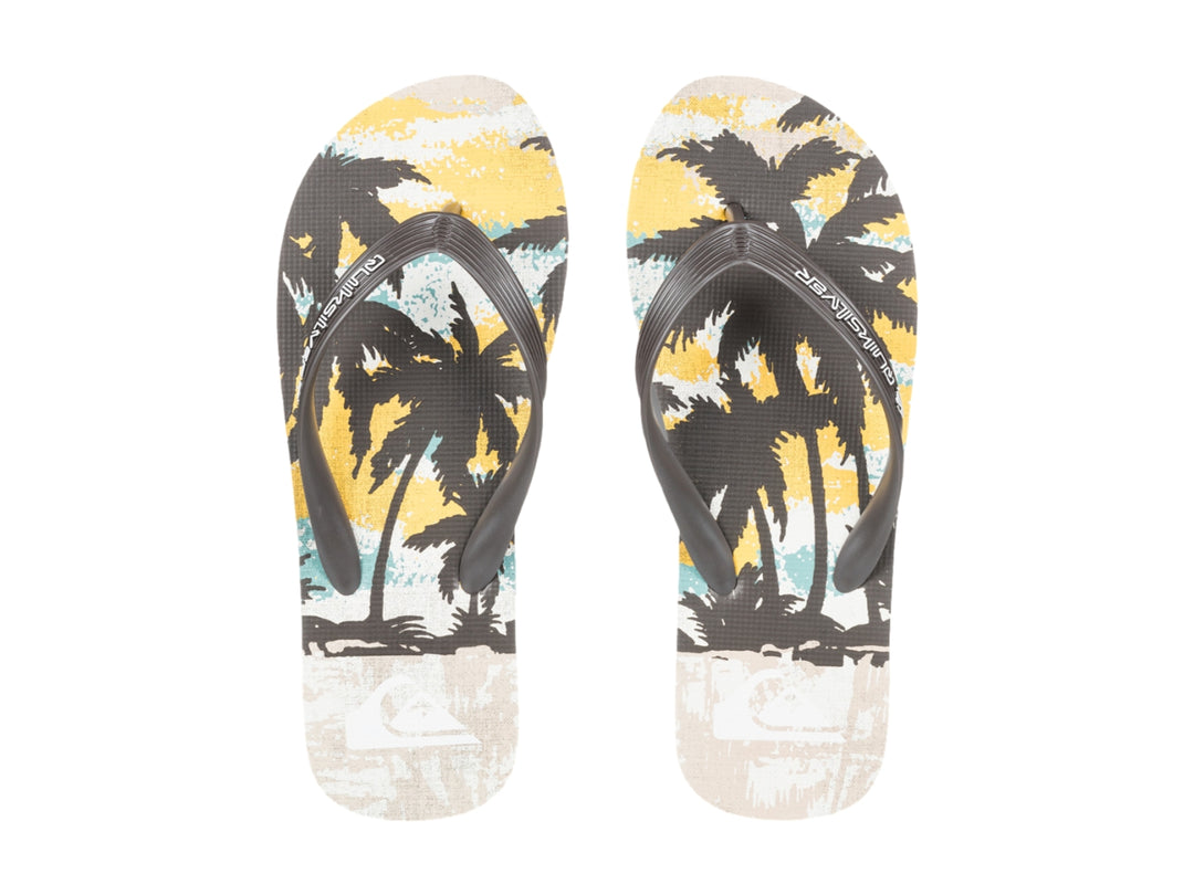 Sandalias Quiksilver de color blanco y negro con diseño tropical en la plantilla, vista lateral.