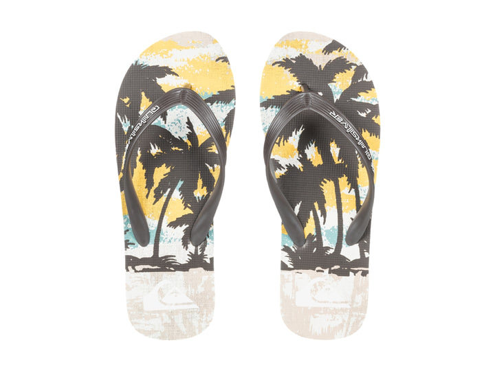 Sandalias Quiksilver de color blanco y negro con diseño tropical en la plantilla, vista lateral.