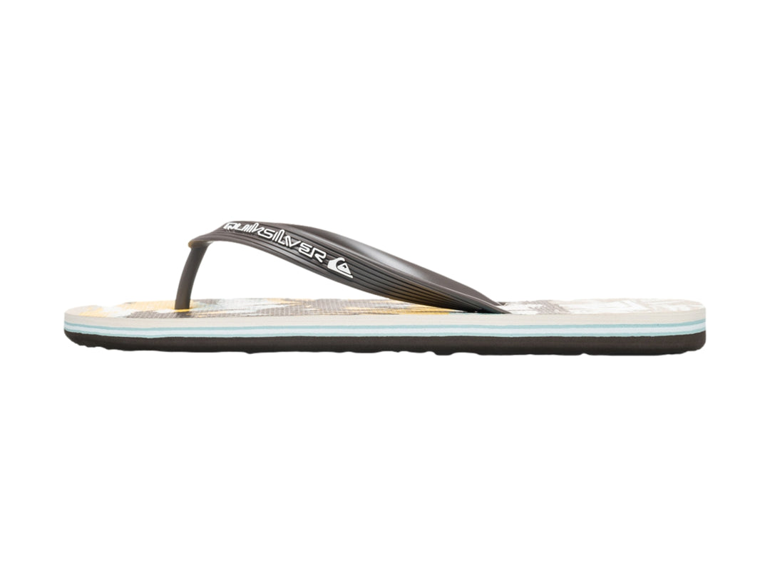 Sandalias Quiksilver de color blanco y negro con diseño tropical en la plantilla, vista lateral.