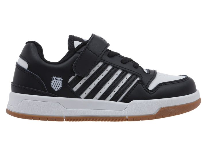Tenis infantiles K-Swiss en color negro y blanco con suela de goma marrón y cierre de velcro.