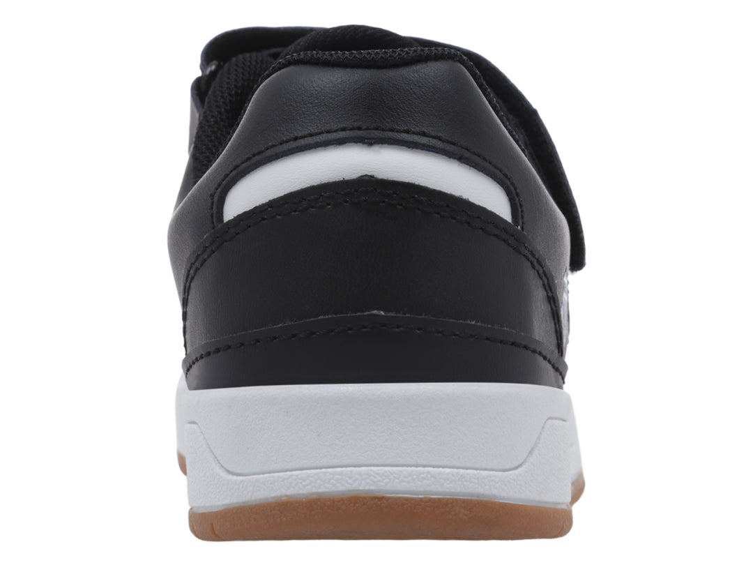 Tenis infantiles K-Swiss en color negro y blanco con suela de goma marrón y cierre de velcro.