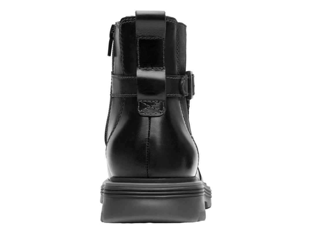 Botín negro de cuero con hebilla lateral y suela gruesa.