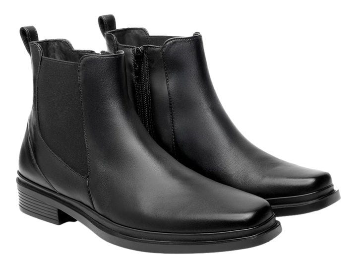 Botín estilo Chelsea de cuero negro con paneles elásticos laterales y suela negra.