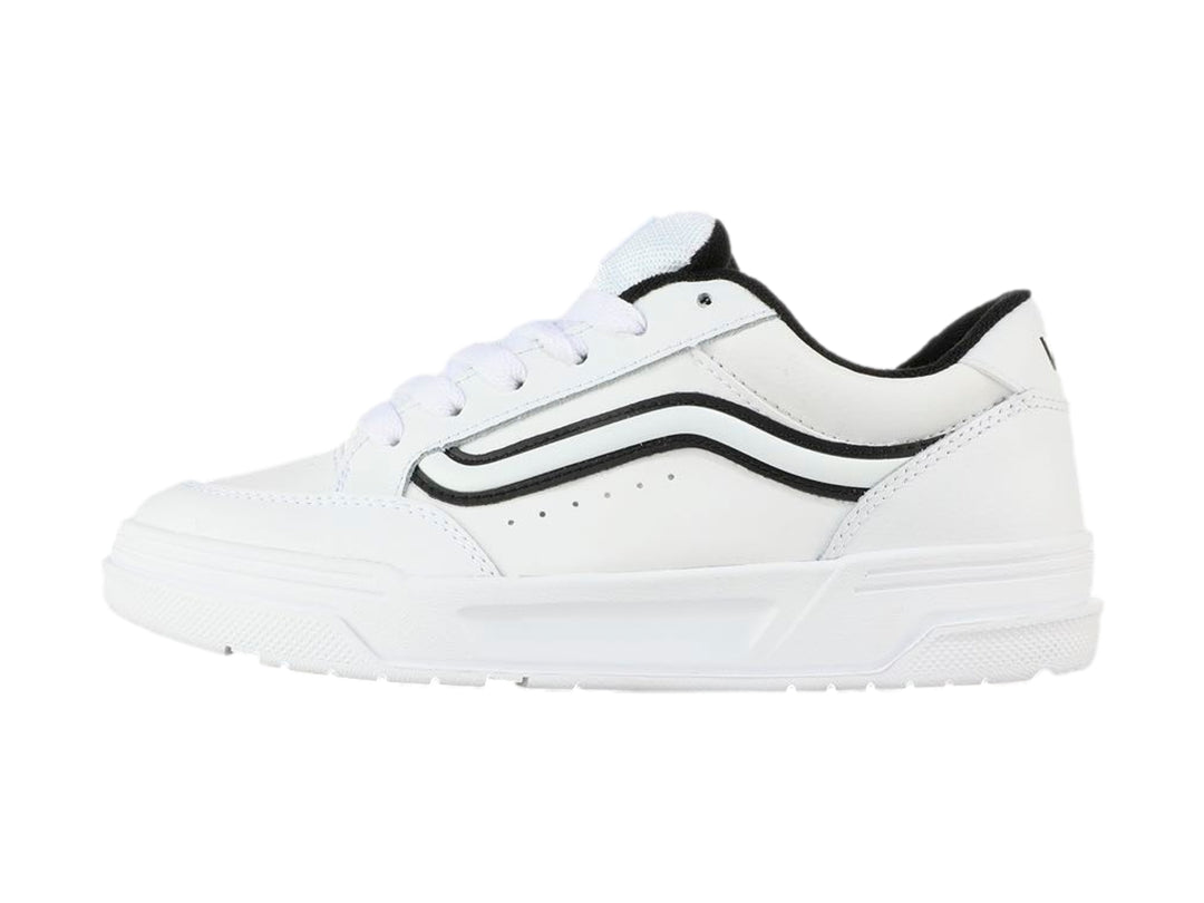 Tenis Vans blancos para Niño con franja lateral negra y suela blanca.