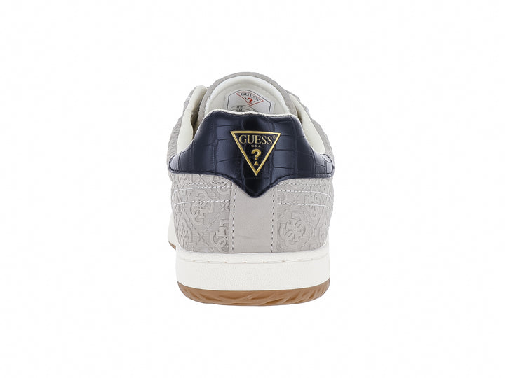 Tenis Guess color natural con franjas azul y rojo en el lateral, suela blanca y detalles en azul marino.