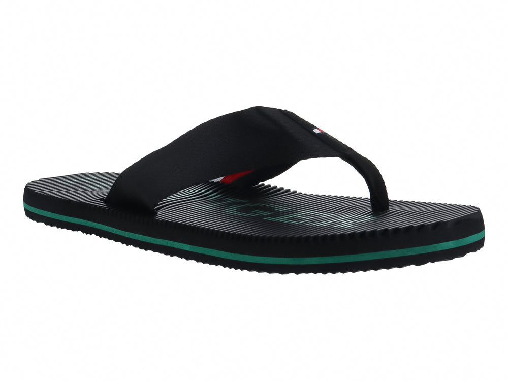 Sandalias Tommy Hilfiger color negro con detalle en la suela color verde y textura estriada.