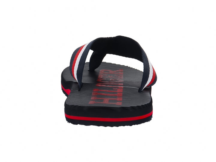 Sandalias Tommy Hilfiger azul marino con franjas rojas y blancas en la correa y la suela.