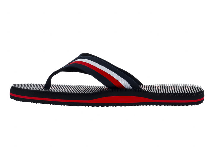 Sandalias Tommy Hilfiger azul marino con franjas rojas y blancas en la correa y la suela.