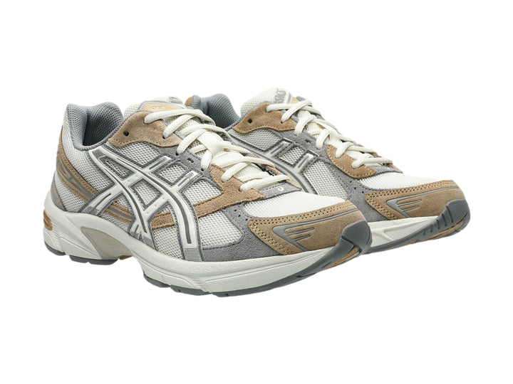 Tenis deportivos ASICS GEL-1130 en colores gris y blanco con detalles en beige, vista lateral.