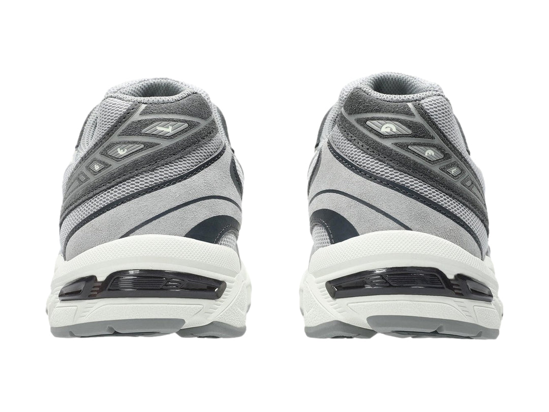 Tenis deportivos ASICS GEL-1130 en color gris cemento con detalles en blanco y suela blanca.