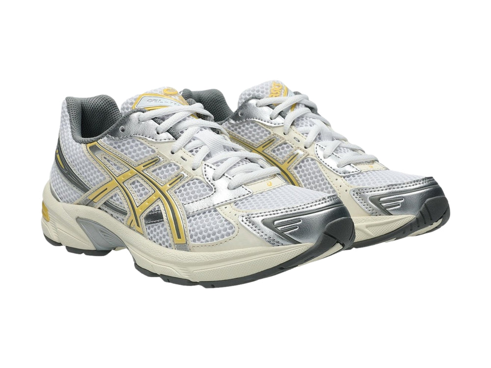 Tenis deportivos ASICS GEL-1130 color blanco con detalles en amarillo pálido y gris.