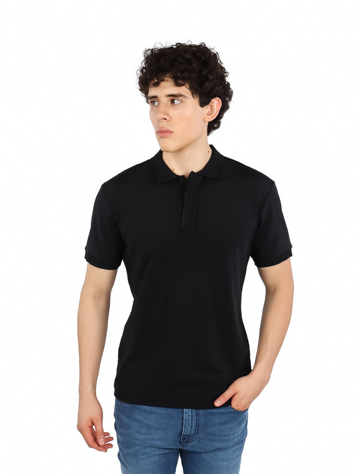 Hombre vistiendo una playera polo de color negro de manga corta.