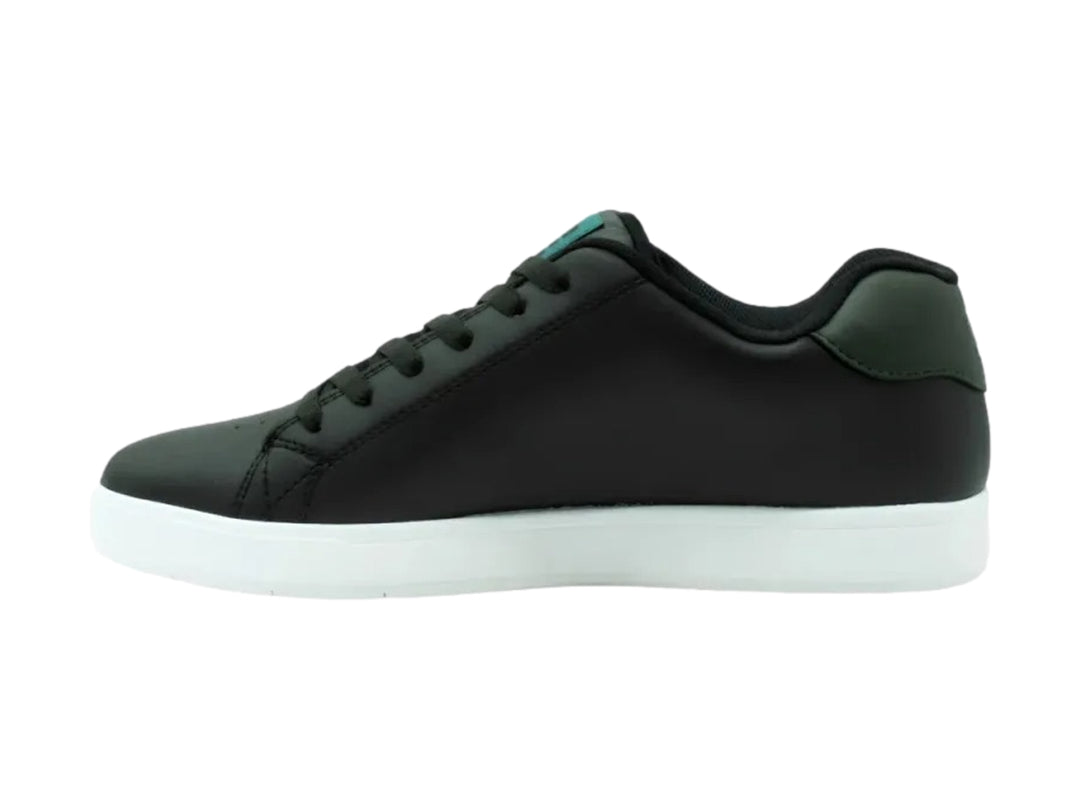 Tenis DC Shoes Gaveler en color negro con suela blanca y detalles en verde azulado.