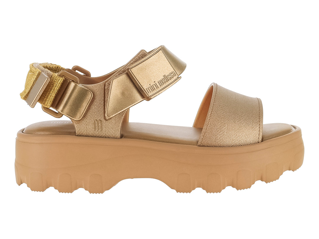 Sandalia Mini Melissa color oro con plataforma gruesa y suela dentada para niños.