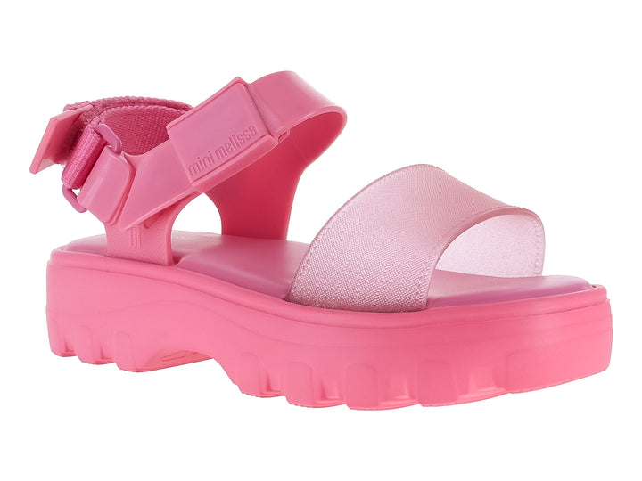 Sandalias Mini Melissa color rosa con plataforma gruesa y suela dentada para niña.