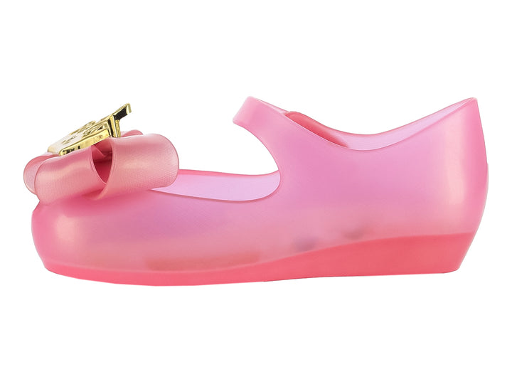Zapato Mary Jane rosa translúcido para niña con moño y detalles dorados de Disney Princess.