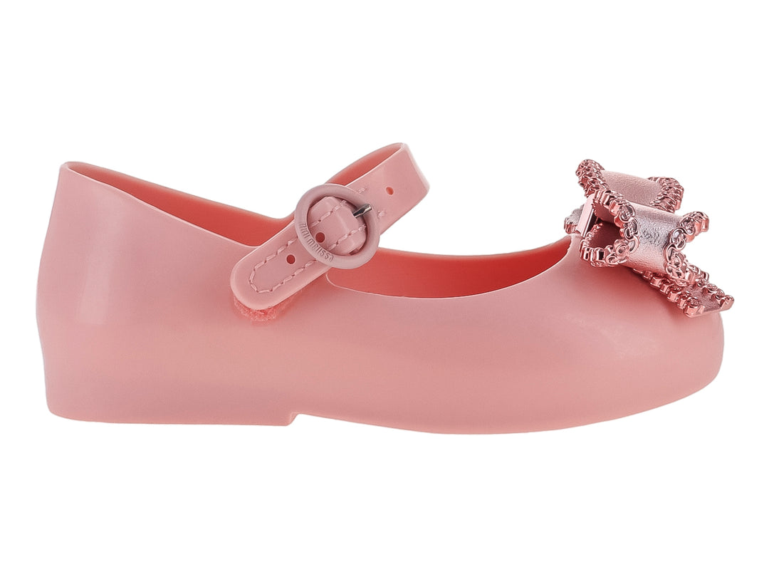 Zapato rosa para niña estilo Mary Jane con moño brillante y correa ajustable.
