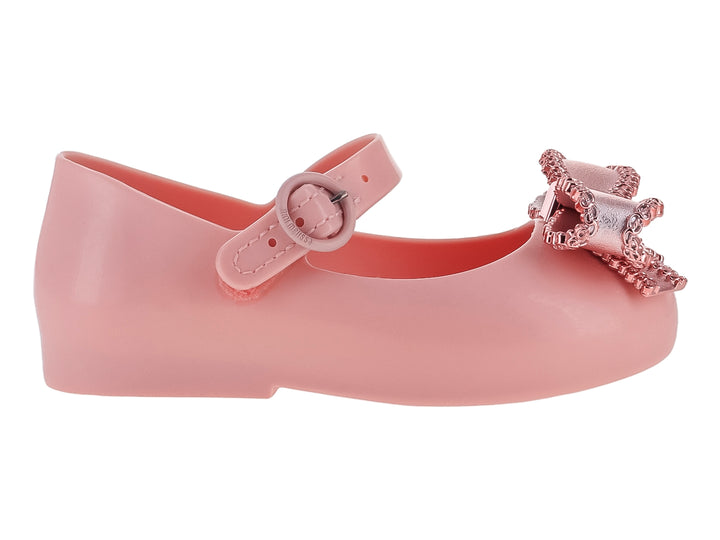Zapato rosa para niña estilo Mary Jane con moño brillante y correa ajustable.