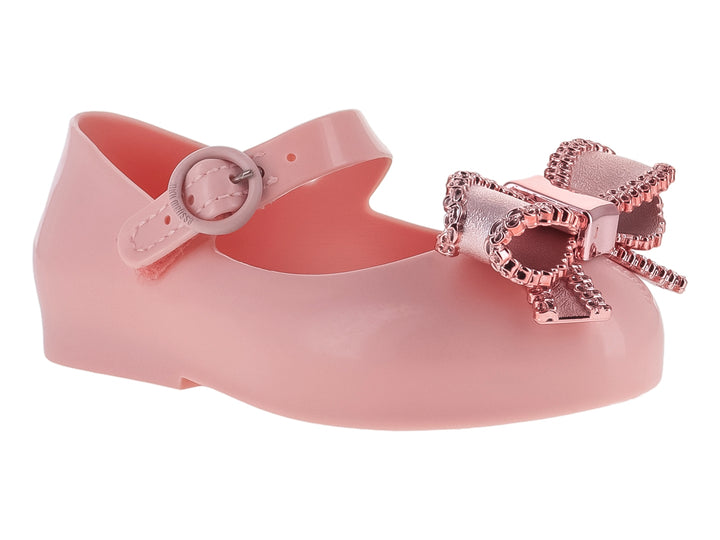 Zapato rosa para niña estilo Mary Jane con moño brillante y correa ajustable.