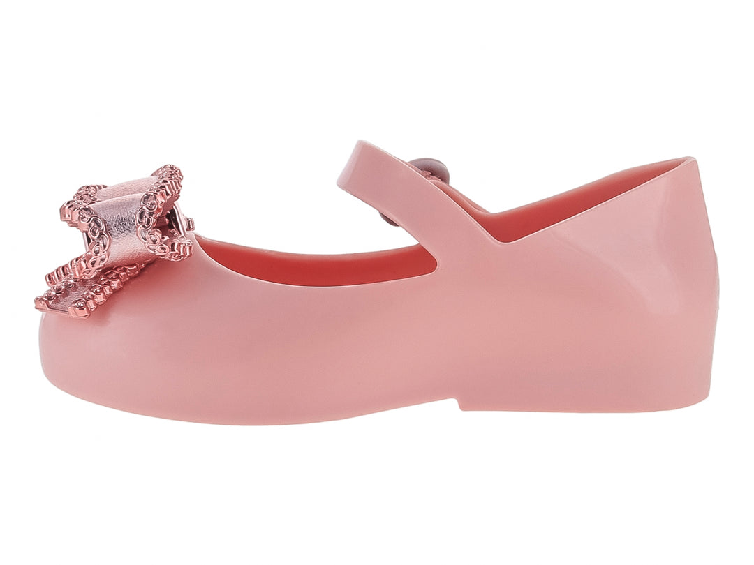 Zapato rosa para niña estilo Mary Jane con moño brillante y correa ajustable.