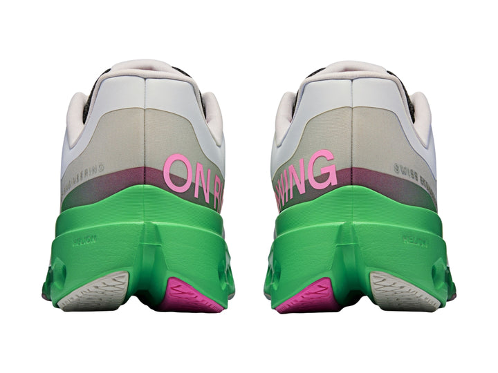 Tenis deportivos On Cloud color gris con suela verde brillante y detalles en rosa.