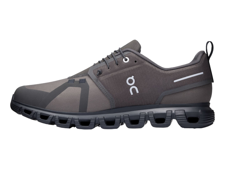 Tenis deportivos On Cloud color gris oscuro y negro con suela característica de cápsulas y tejido transpirable.