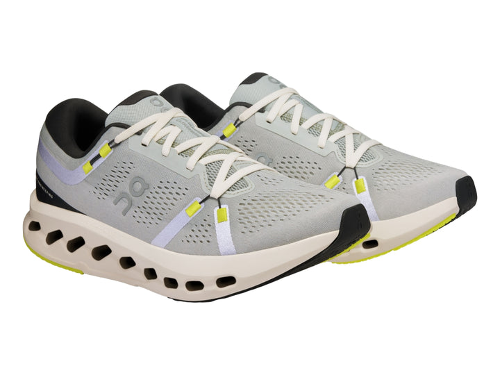 Tenis deportivos On Cloud Cloudsurfer 2 color gris glacier con suela marfil y detalles en amarillo neón.