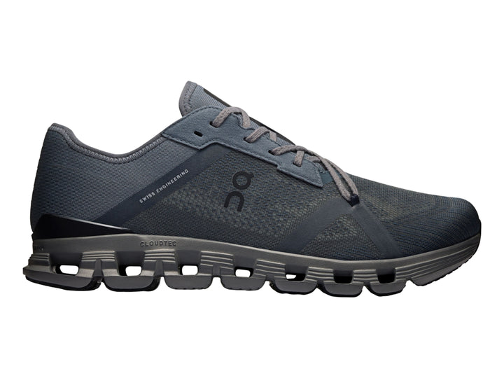 Tenis deportivos On Cloud X 4 AD en color negro y gris oscuro con suela segmentada característica.
