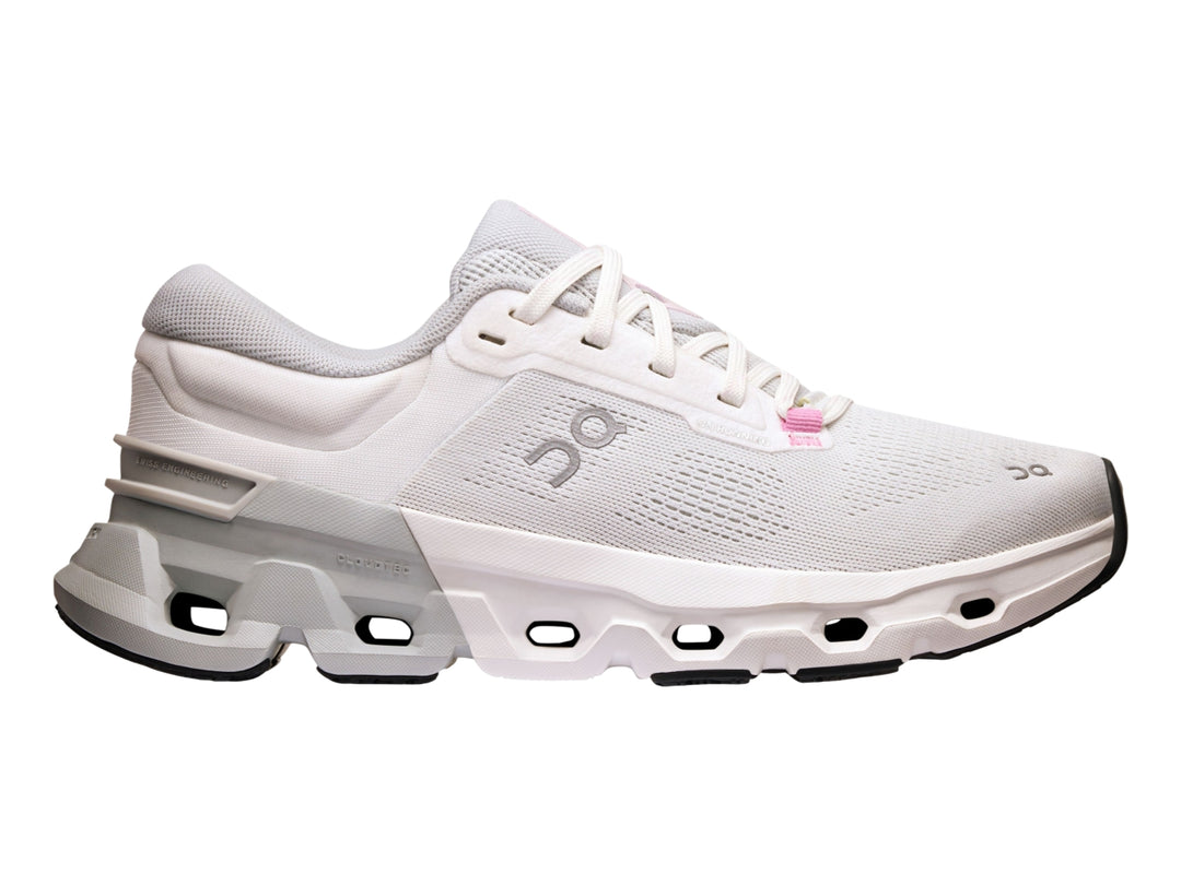 Tenis deportivos On Cloud color blanco y gris con suela tecnológica y detalles en rosa.