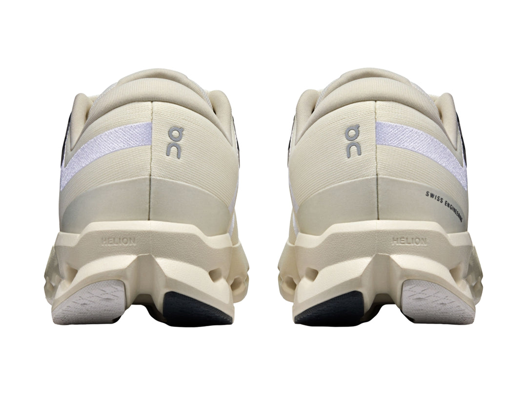 Tenis deportivos On Cloud color marfil con suela blanca perforada y detalles en gris.