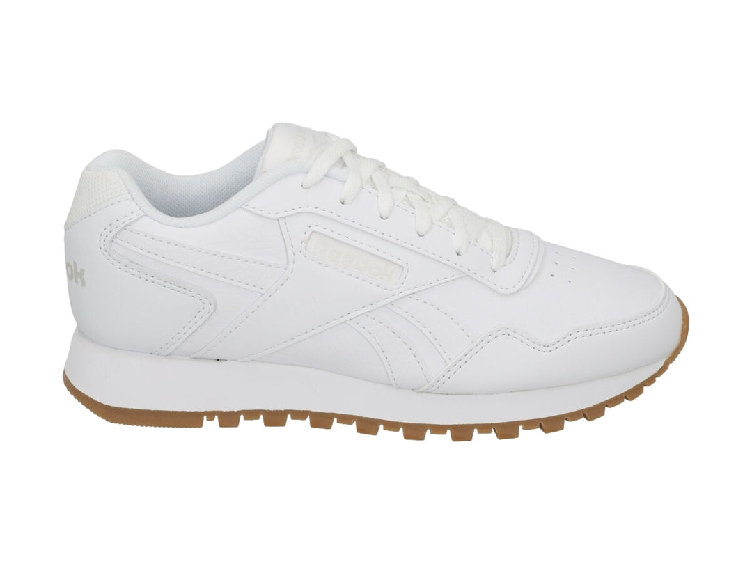 Tenis Reebok blancos con suela de goma marrón, diseño deportivo y casual.