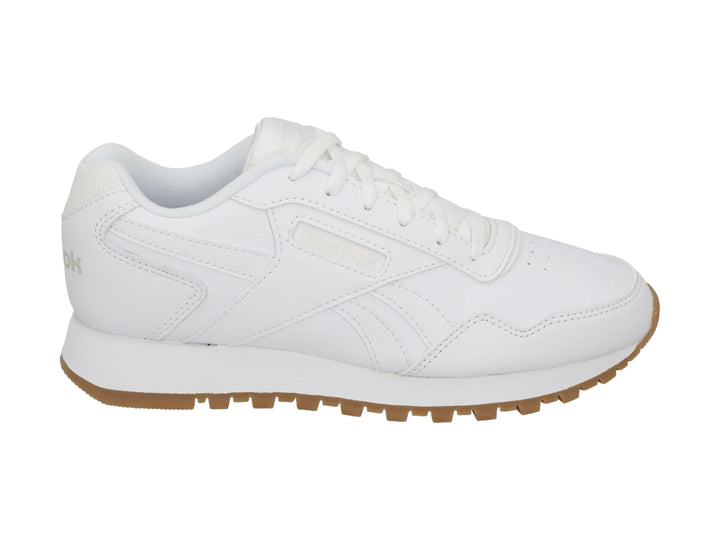 Tenis Reebok blancos con suela de goma marrón, diseño deportivo y casual.