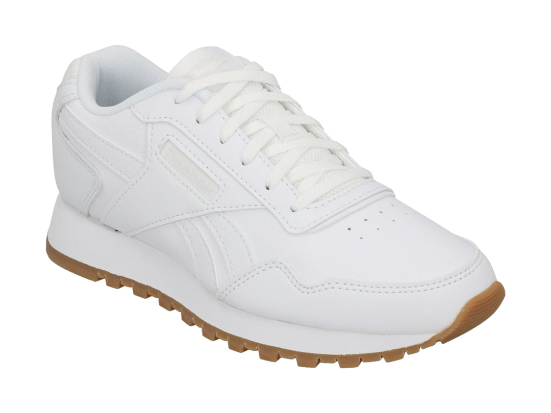 Tenis Reebok blancos con suela de goma marrón, diseño deportivo y casual.