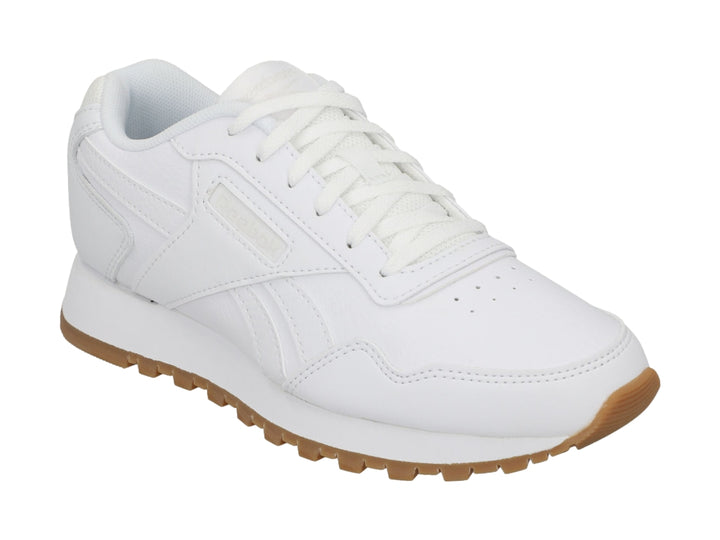 Tenis Reebok blancos con suela de goma marrón, diseño deportivo y casual.
