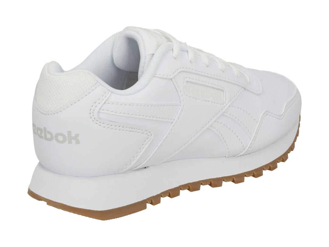 Tenis Reebok blancos con suela de goma marrón, diseño deportivo y casual.