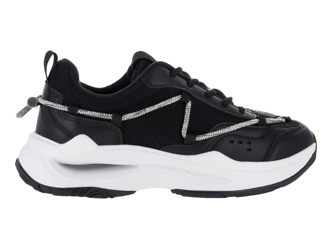 Tenis deportivos Clasben Karen en color negro con suela blanca gruesa y detalles de cordones decorativos grises.