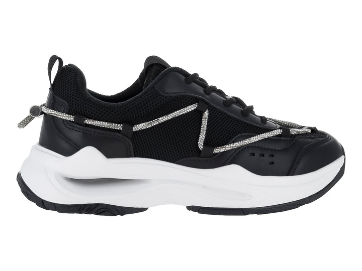 Tenis deportivos Clasben Karen en color negro con suela blanca gruesa y detalles de cordones decorativos grises.